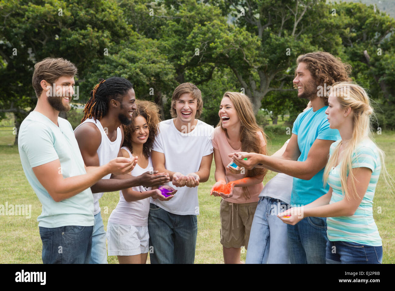 Friends having fun with powder paint Stock Photo - Alamy