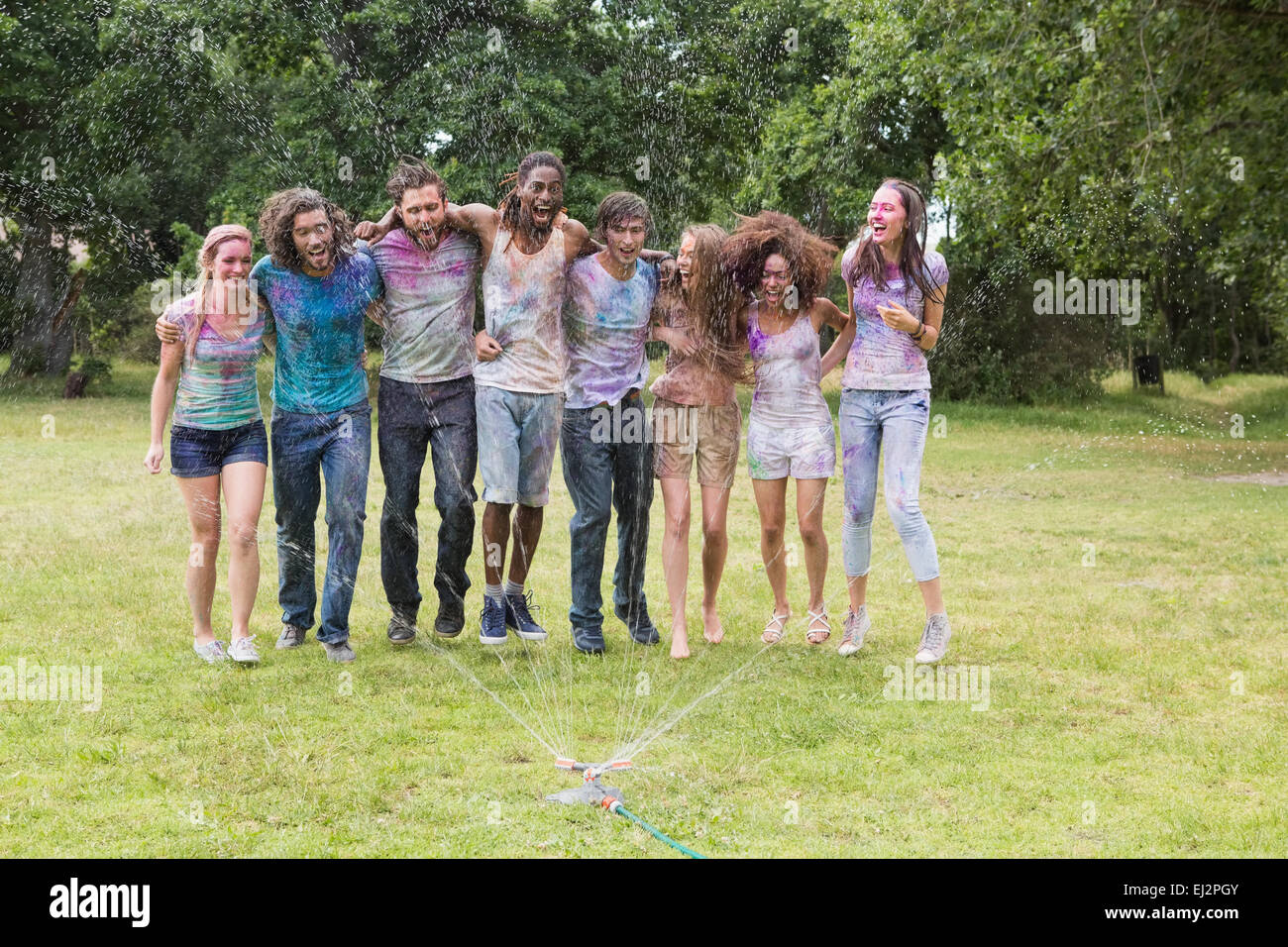 Young friends having fun with powder paint Stock Photo - Alamy