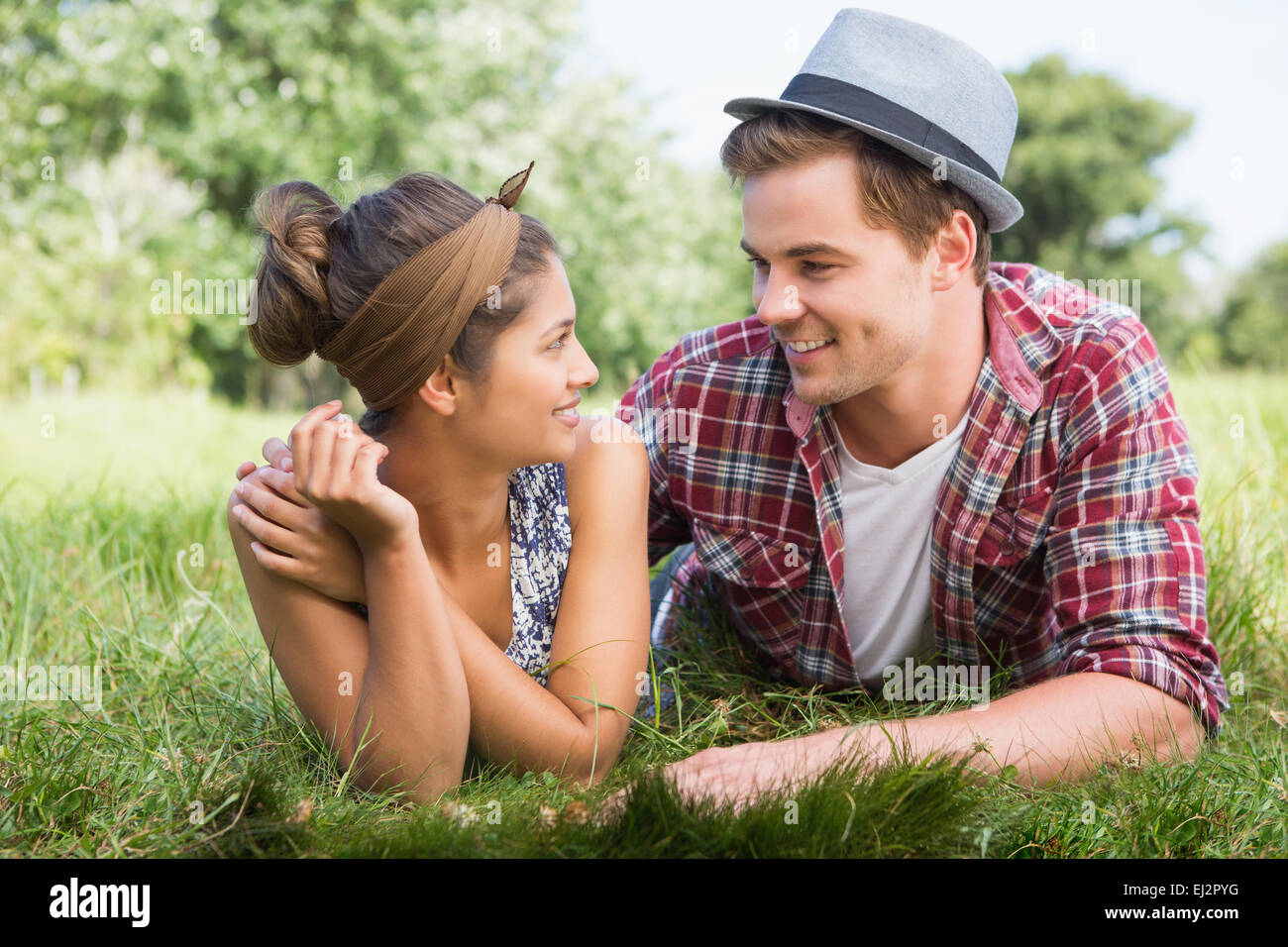 Couple relaxing in the park Stock Photo - Alamy