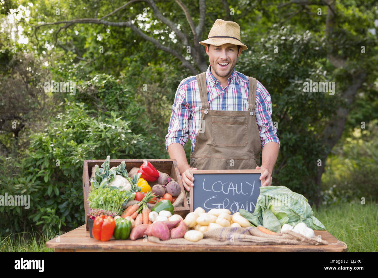 Happy farmer showing his produce Stock Photo - Alamy