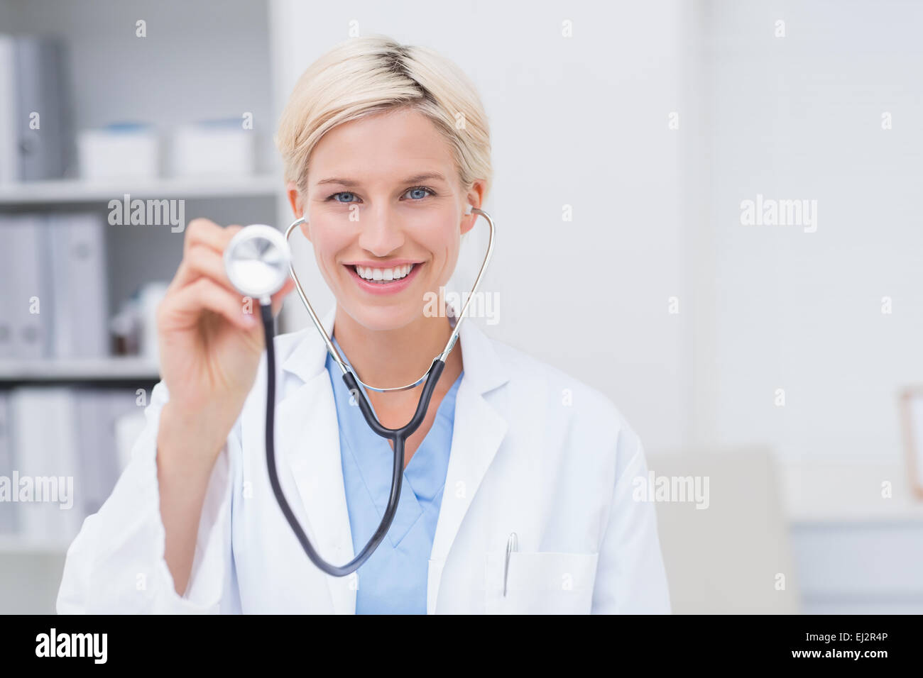 Happy Female Doctor Holding Stethoscope Stock Photo - Alamy