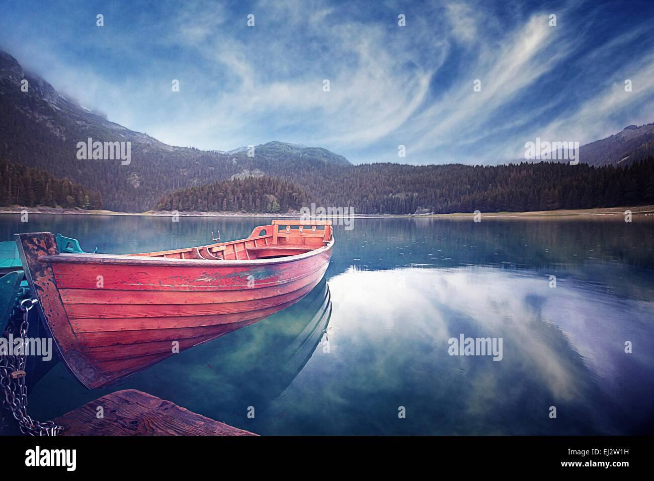 wooden boat on a mountain lake landscape mountain sky Stock Photo - Alamy
