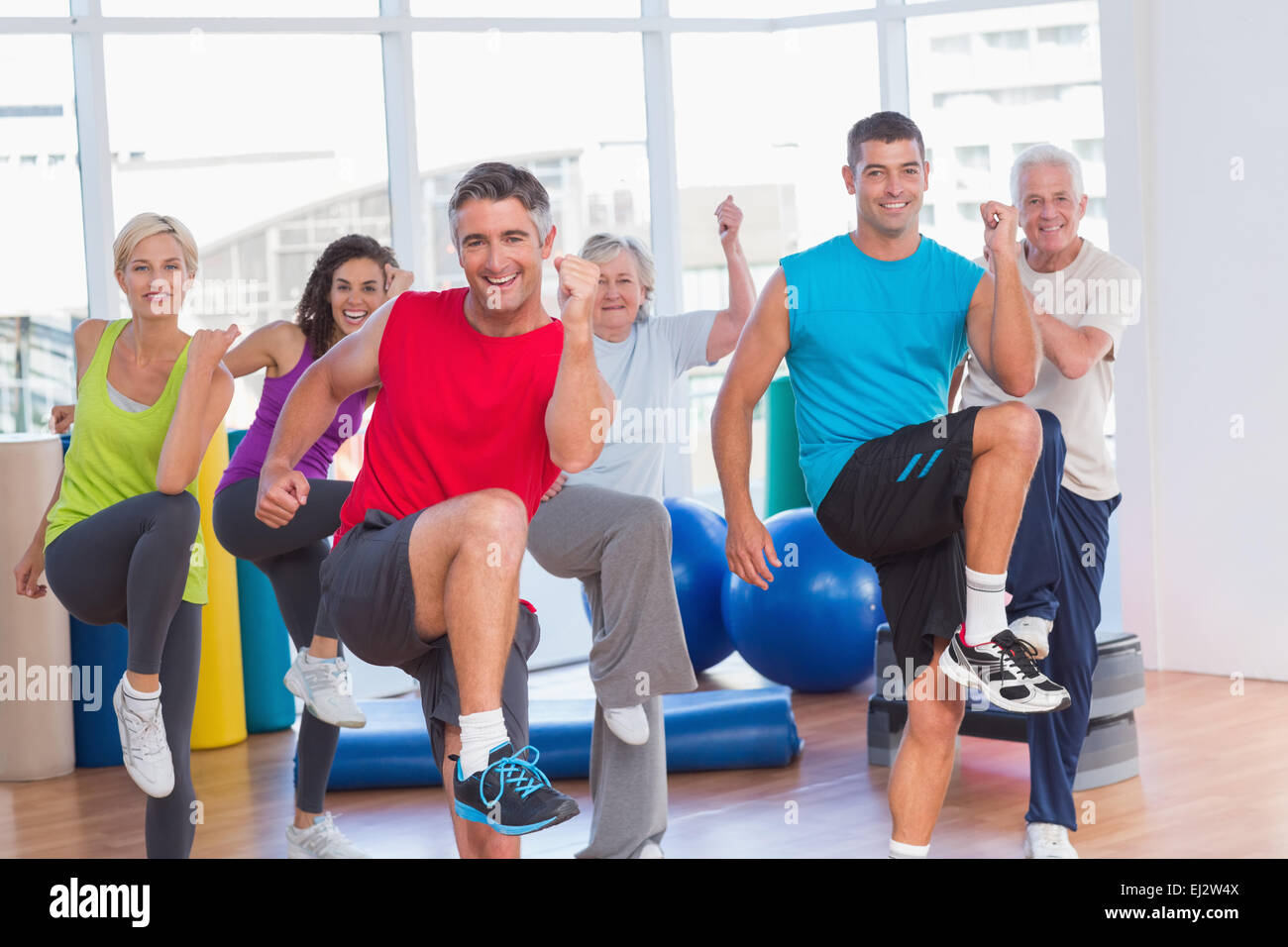 People performing aerobics exercise in gym class Stock Photo Alamy