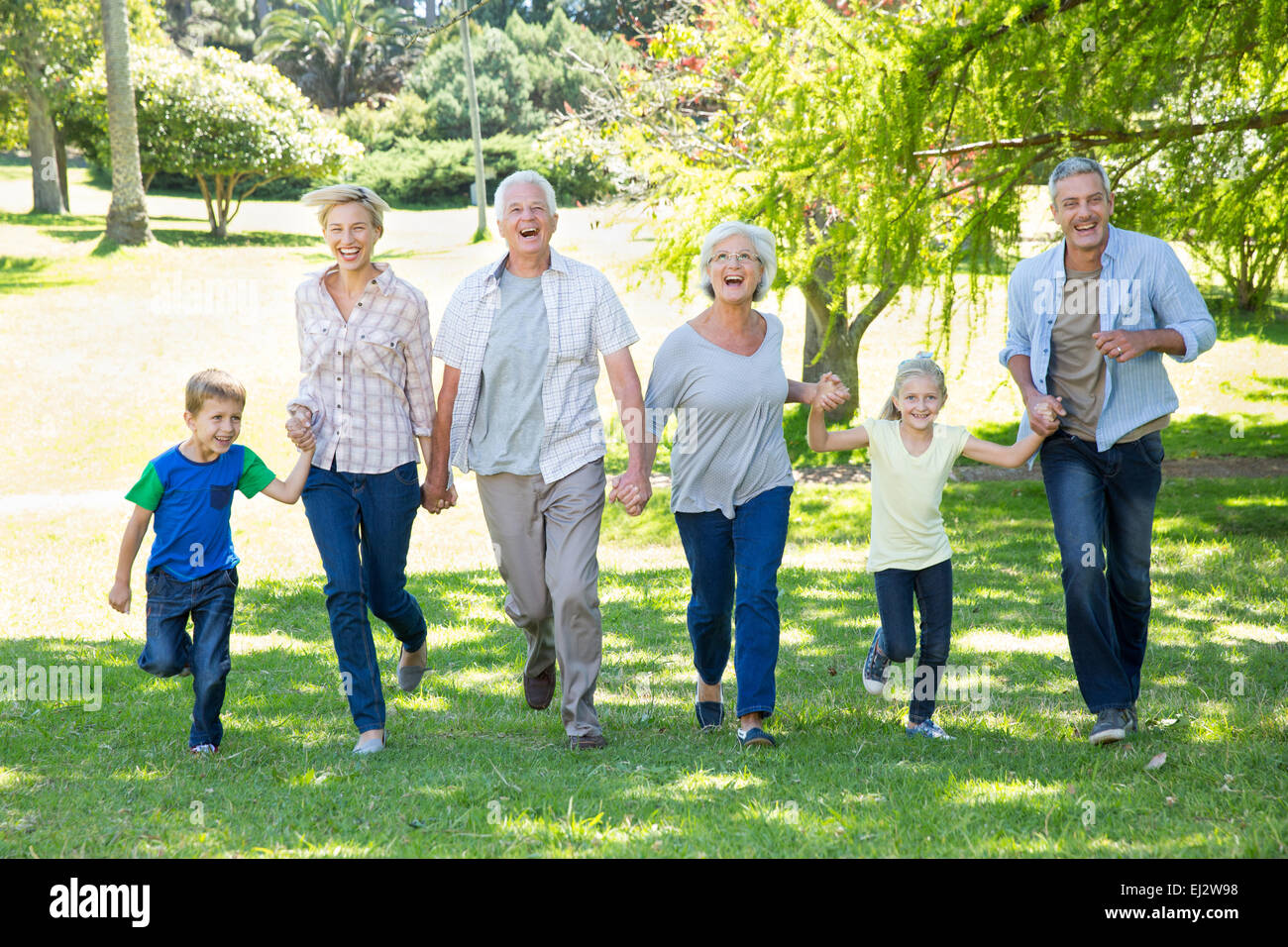 Happy family running in the park Stock Photo