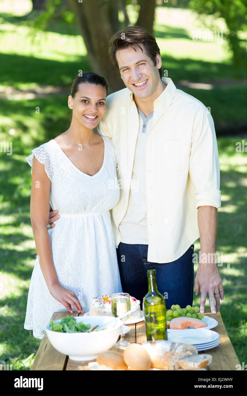 Happy couple smiling at the camera in the park Stock Photo - Alamy
