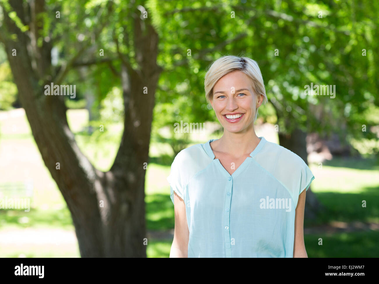 Pretty blonde smiling at the camera Stock Photo - Alamy