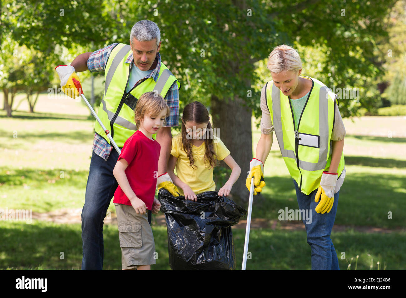 Happy family collecting rubbish Stock Photo