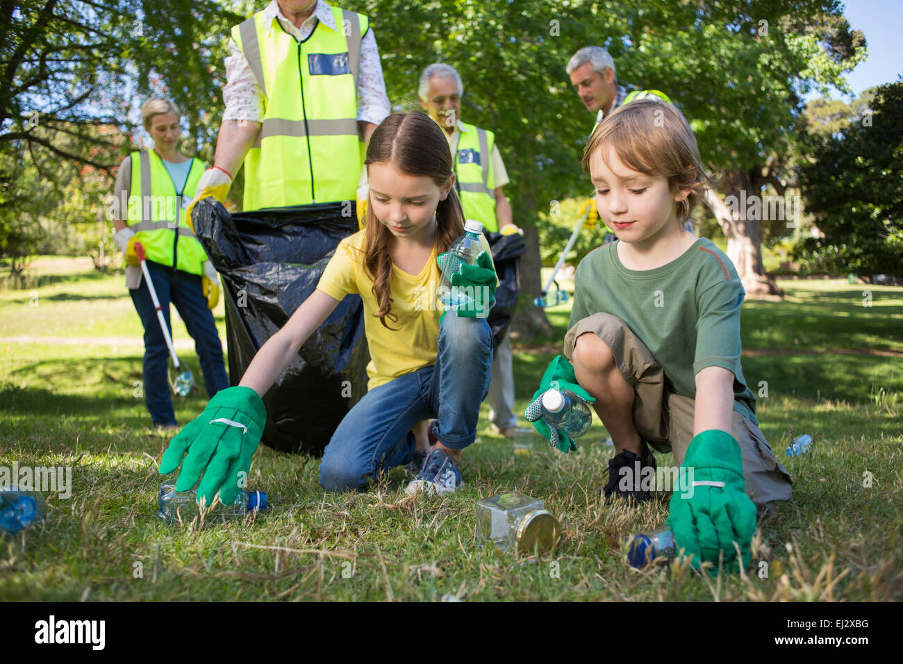 Happy family collecting rubbish Stock Photo Alamy