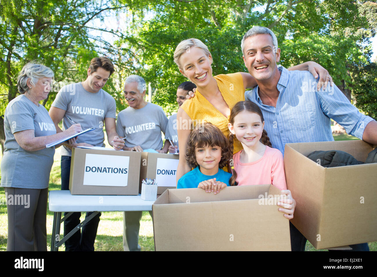 Happy family holding boxes and smiling at the camera Stock Photo - Alamy