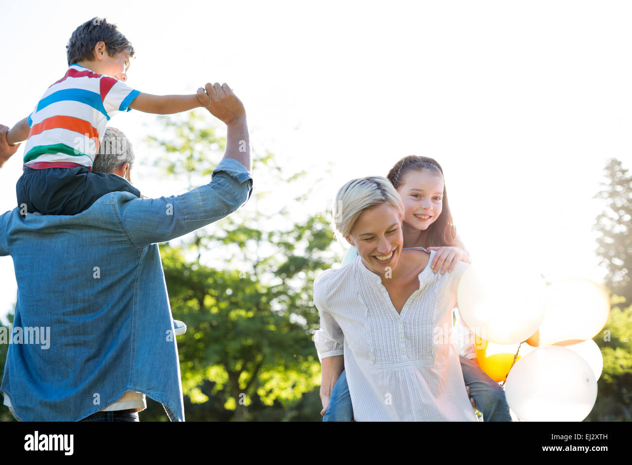 Happy family playing at the park Stock Photo - Alamy