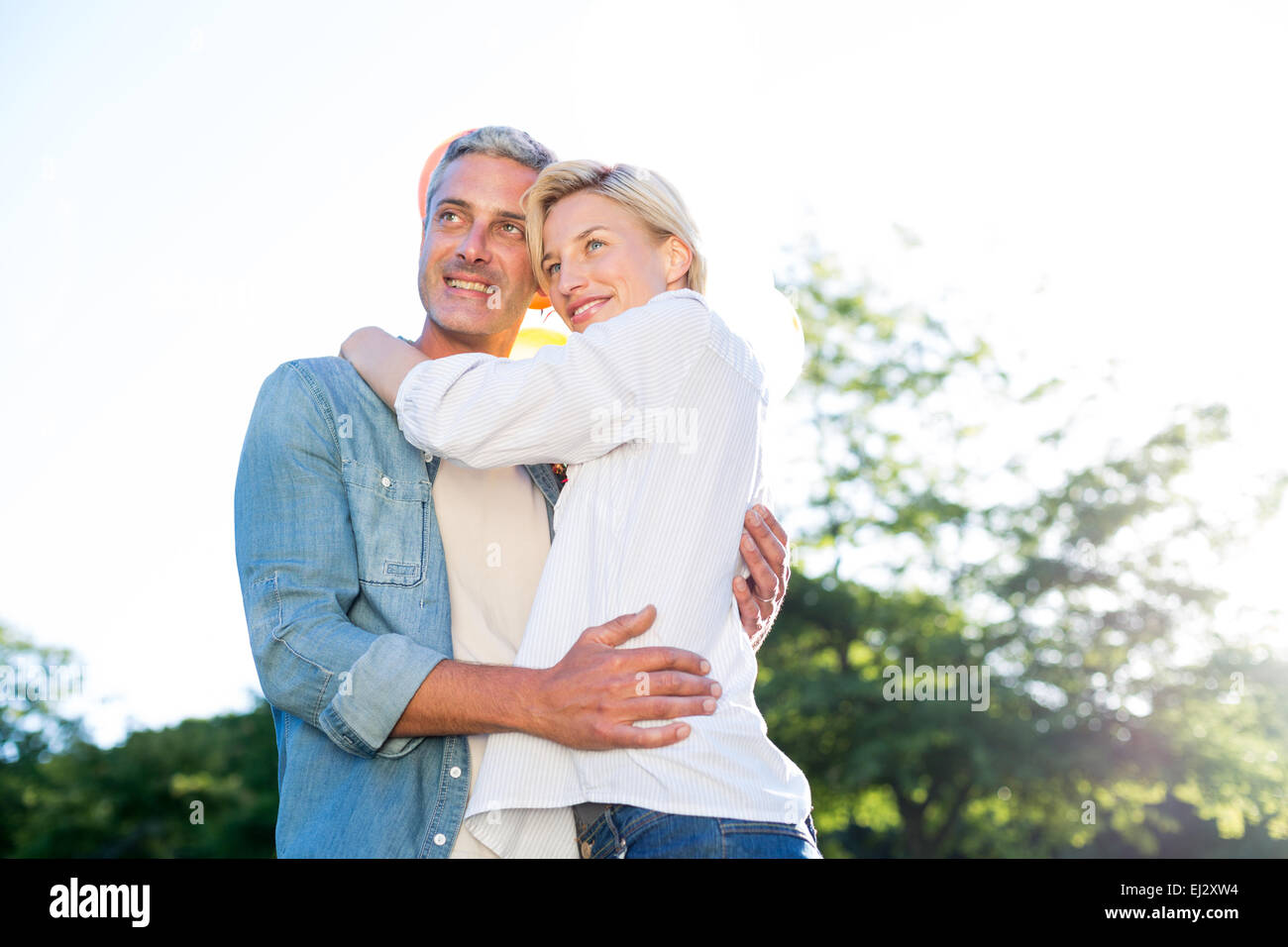 Cute couple hugging at the park Stock Photo - Alamy