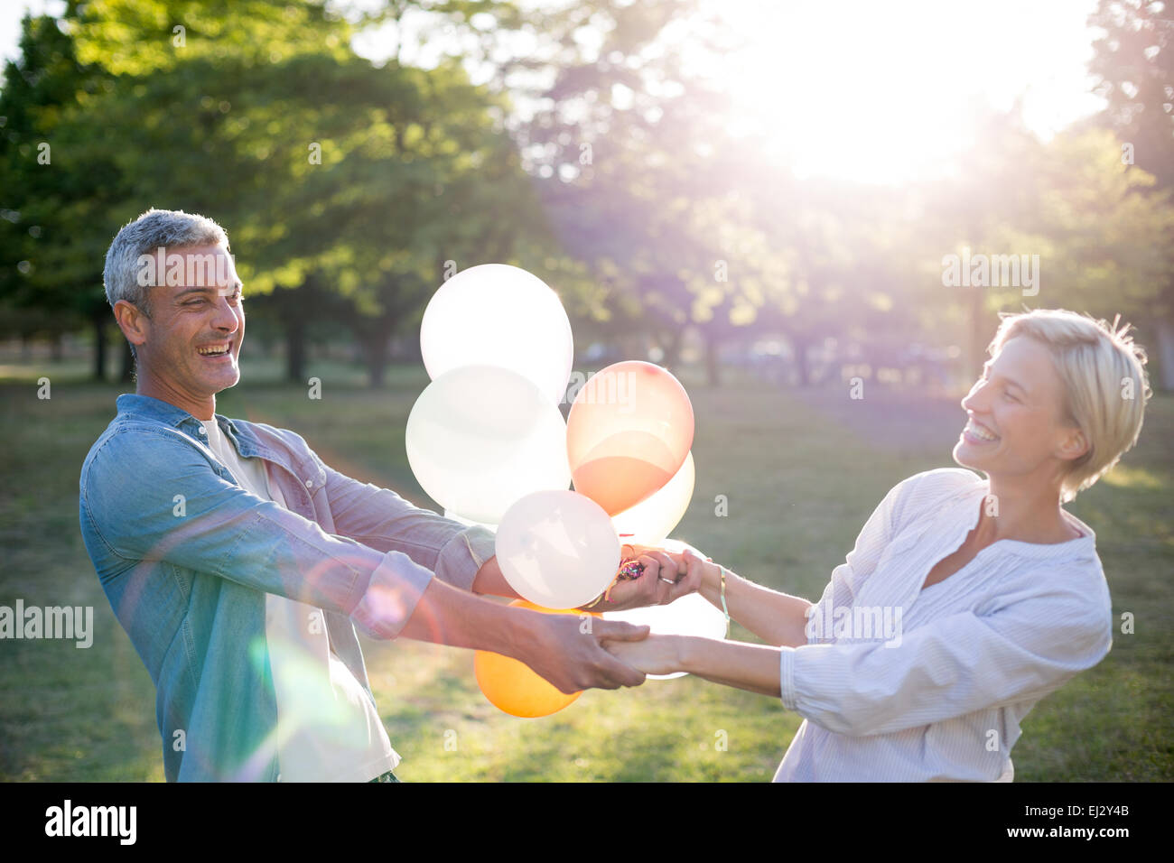 Happy couple having fun at the park Stock Photo - Alamy