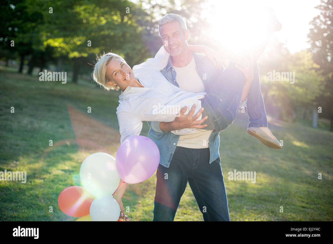 Happy couple having fun at the park Stock Photo - Alamy