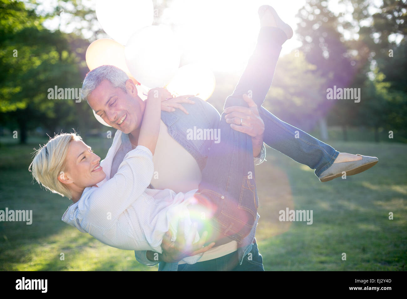 Happy couple having fun at the park Stock Photo - Alamy