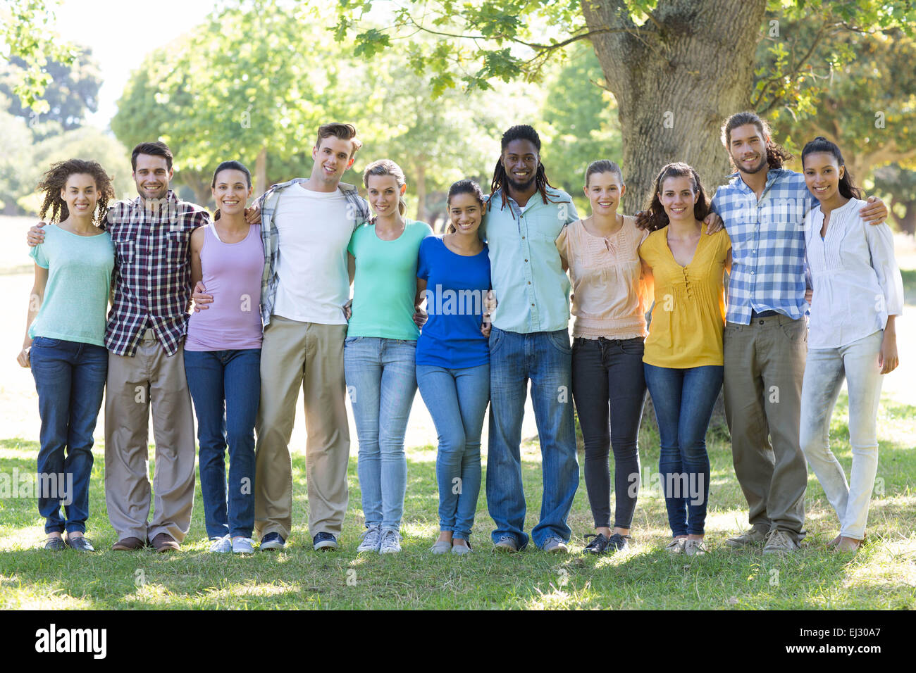 Happy friends in the park Stock Photo - Alamy