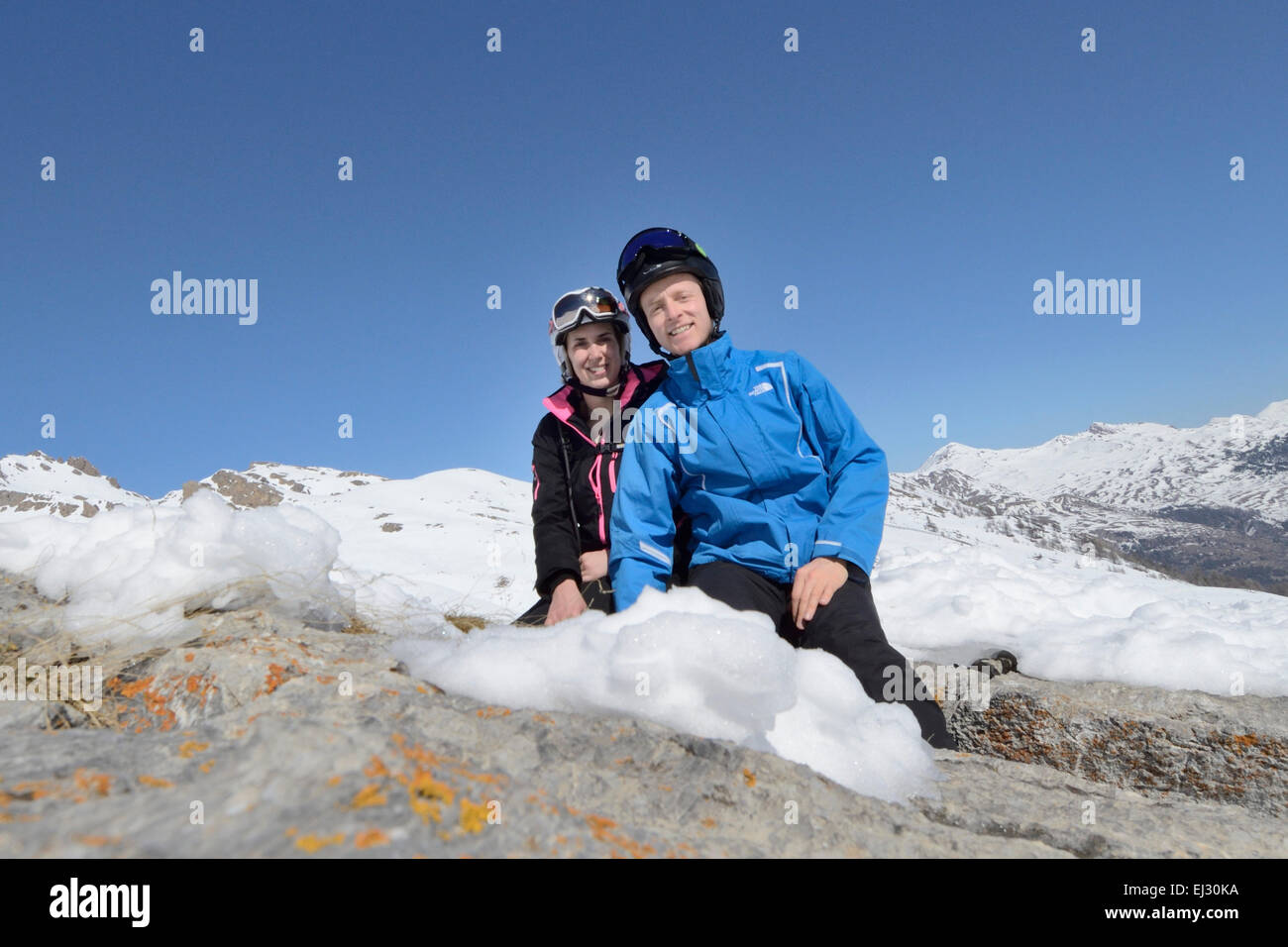 Skiers posing for photo in warm sunny conditions  Stock Photo