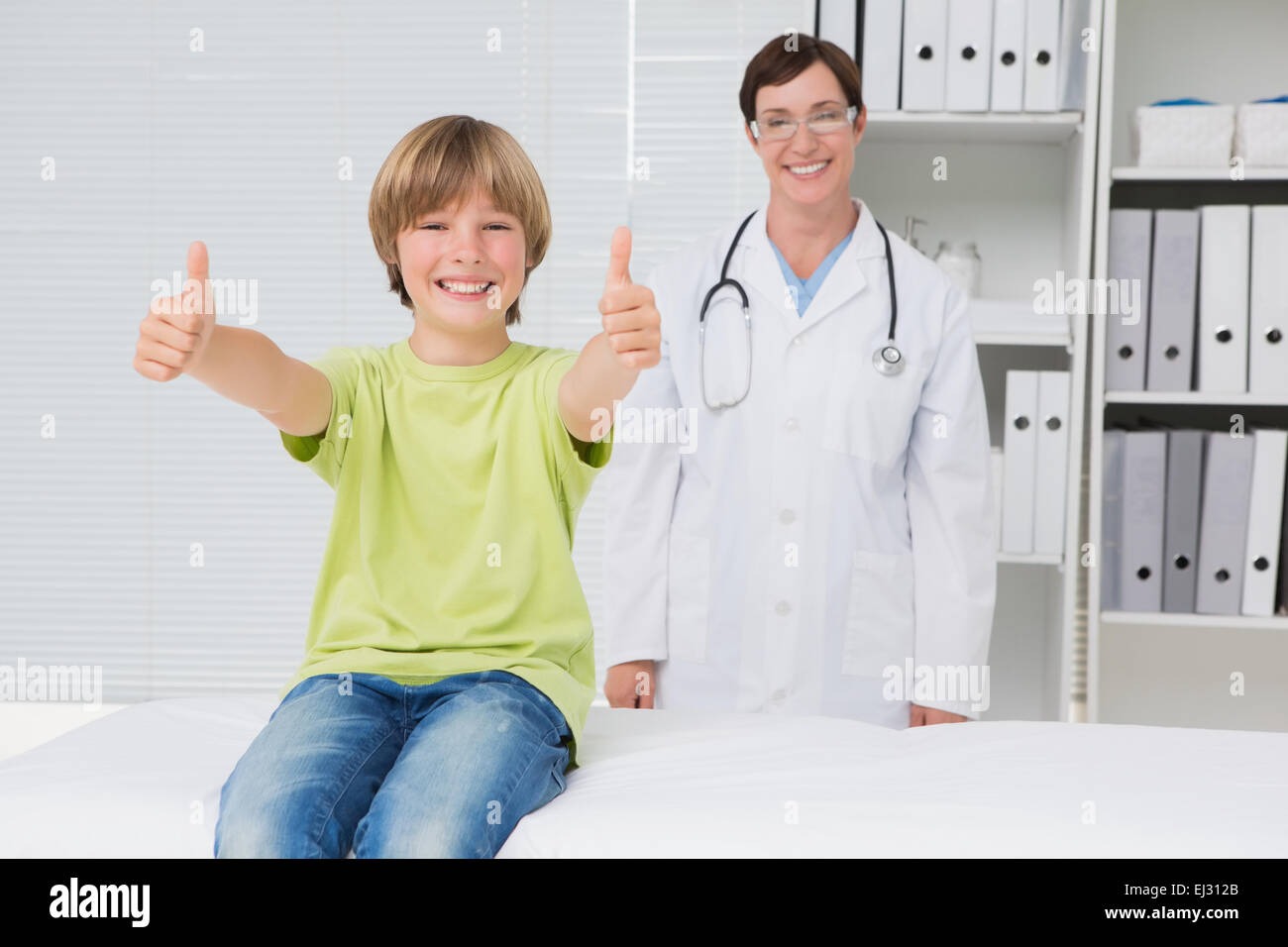 Little sick boy holding hid thumbs Stock Photo