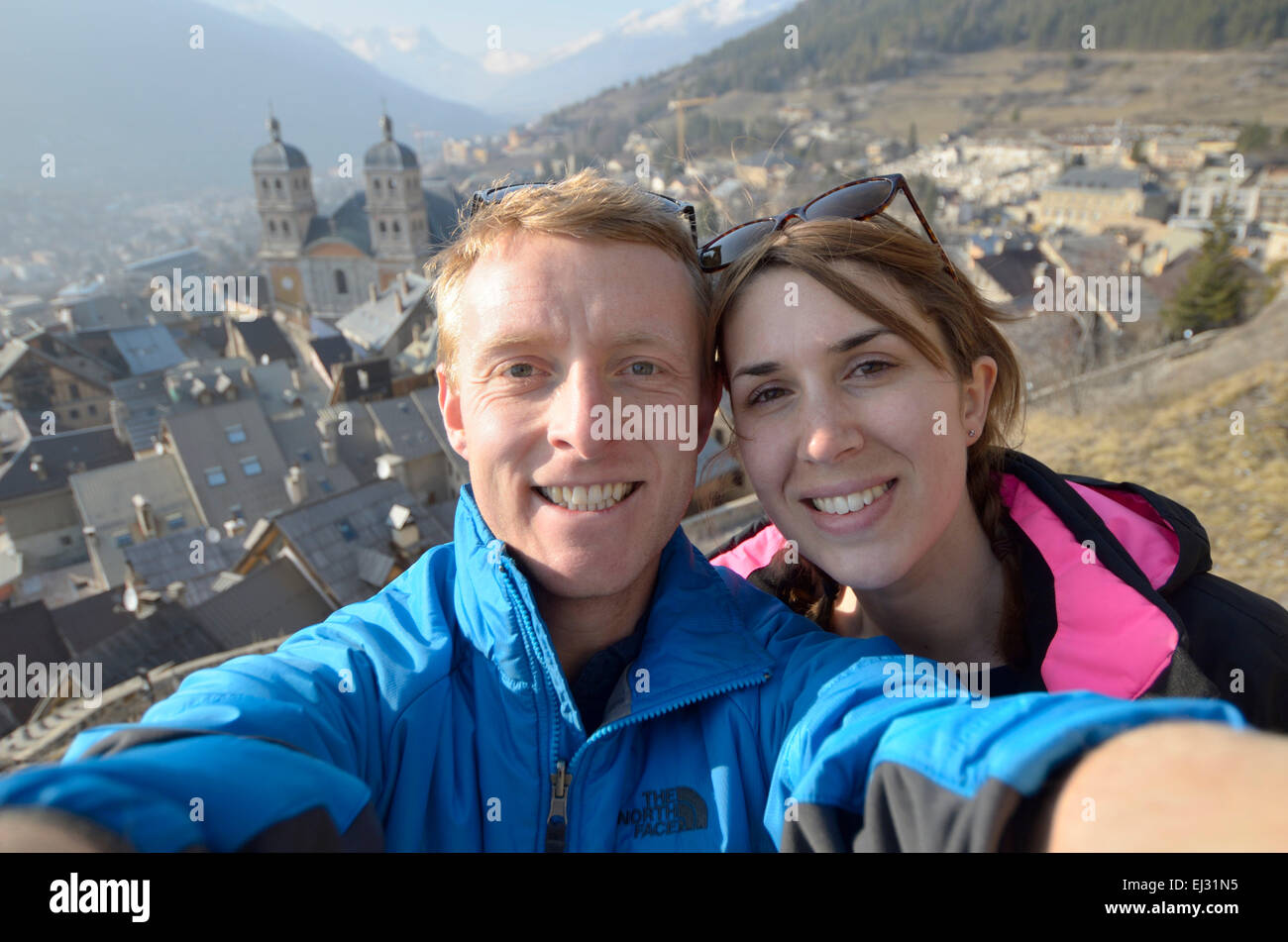 Young couple taking a selfie photo on camera in Briancon France Stock Photo