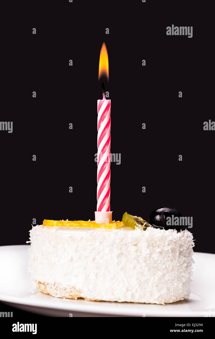 piece of cake with a candle on a dark background Stock Photo - Alamy