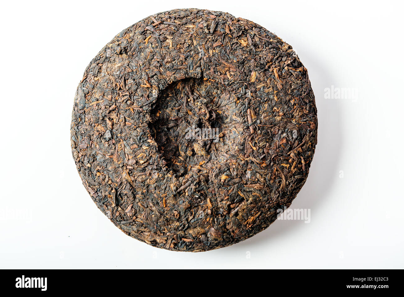 Disc of chinese puer tea on green background Stock Photo - Alamy