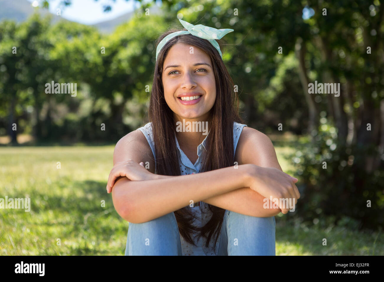 Pretty brunette relaxing in the park Stock Photo - Alamy