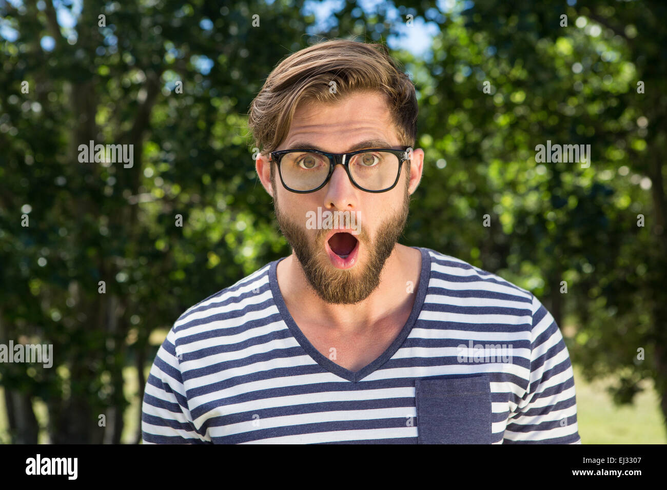 Shocked hipster looking at camera Stock Photo