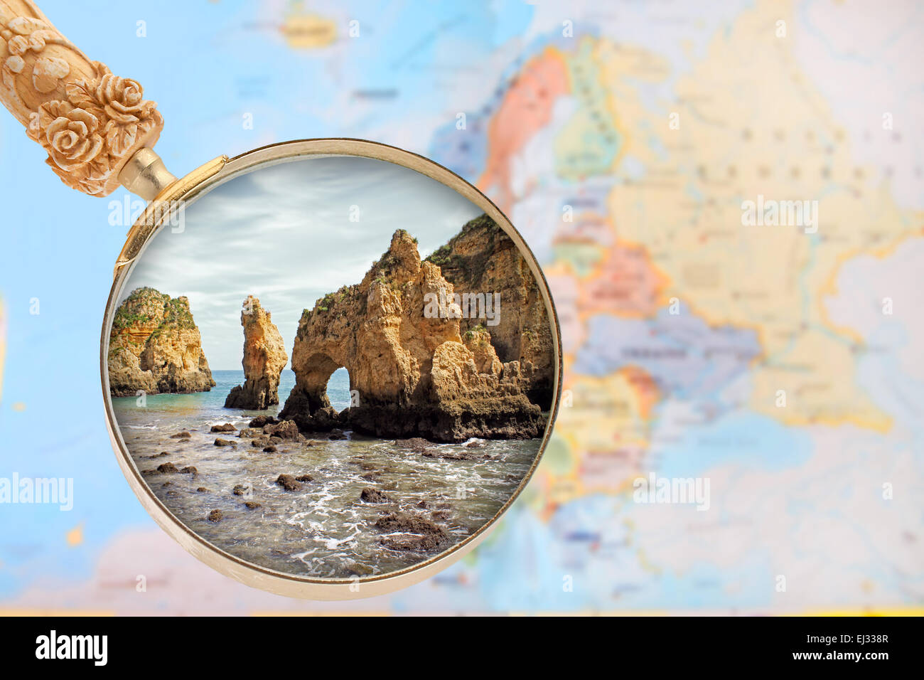 Looking in on Ponte da Piedade in  Portugal with a magnifying glass or loop with European map in the background Stock Photo