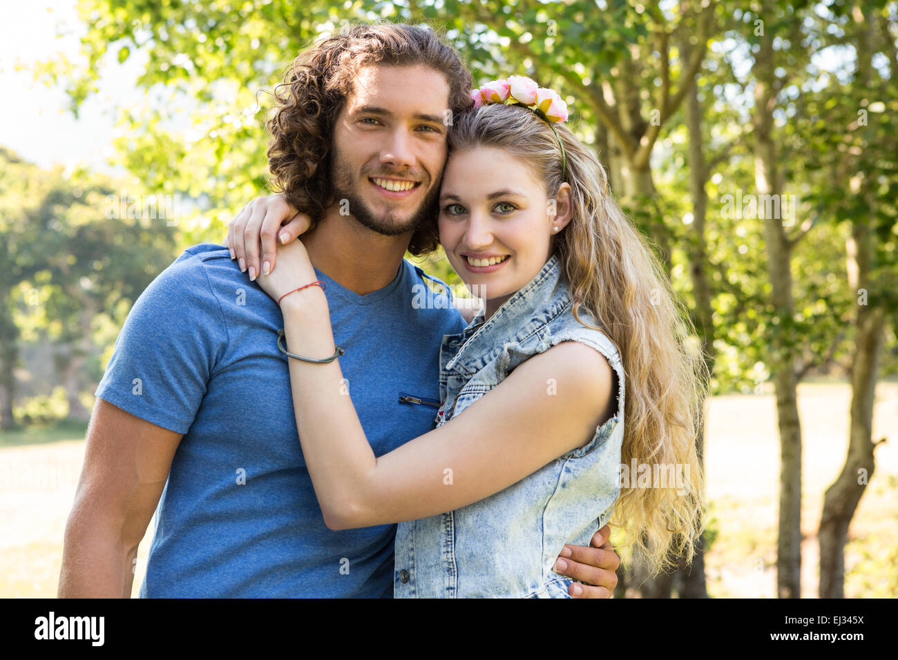 Cute couple smiling at camera Stock Photo - Alamy