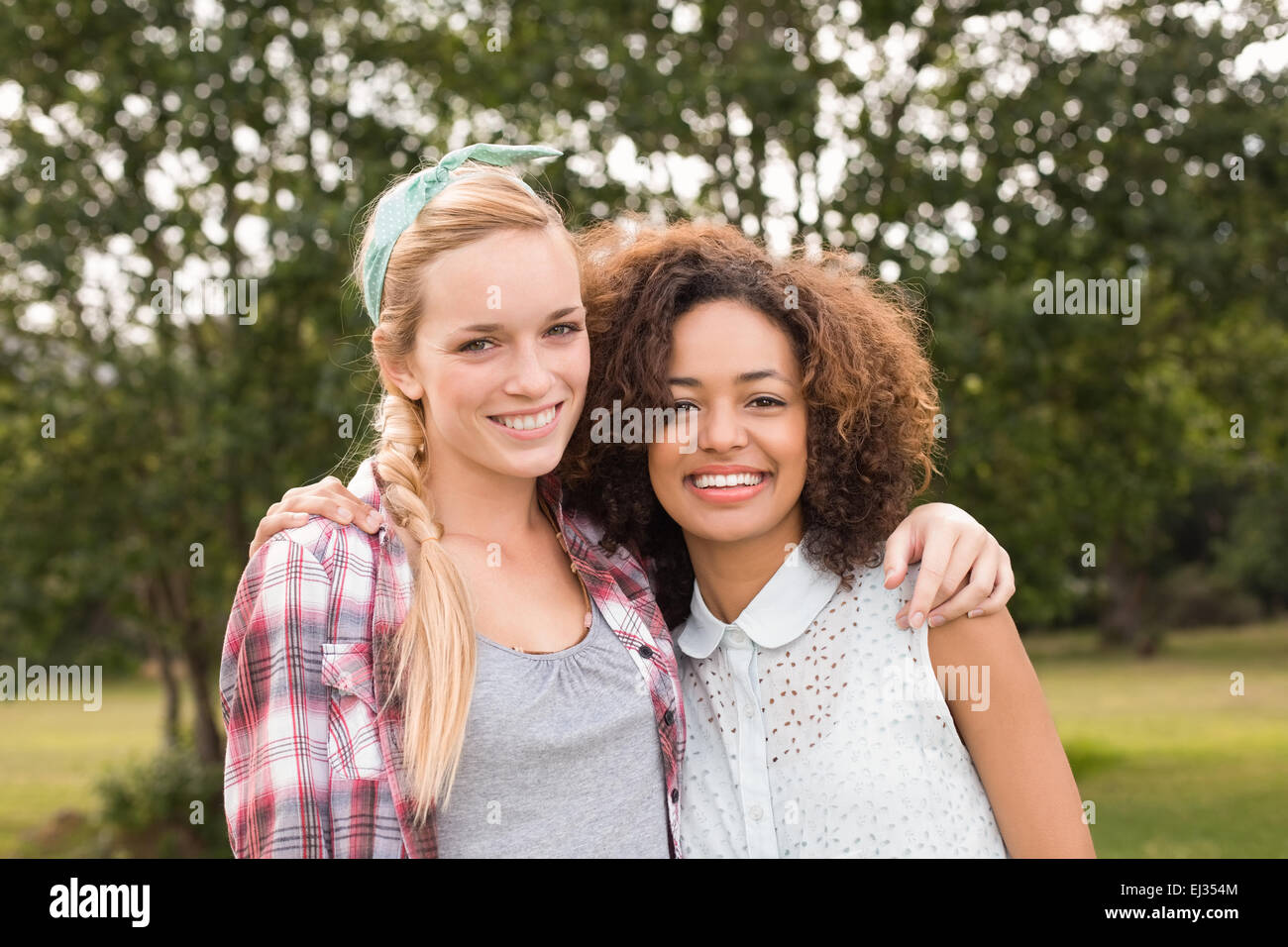 Happy friends in the park Stock Photo - Alamy