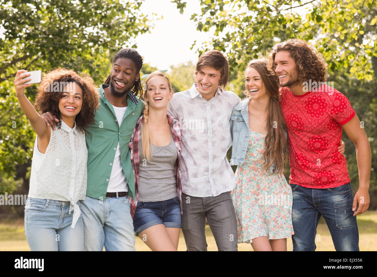 Happy friends in the park taking selfie Stock Photo - Alamy