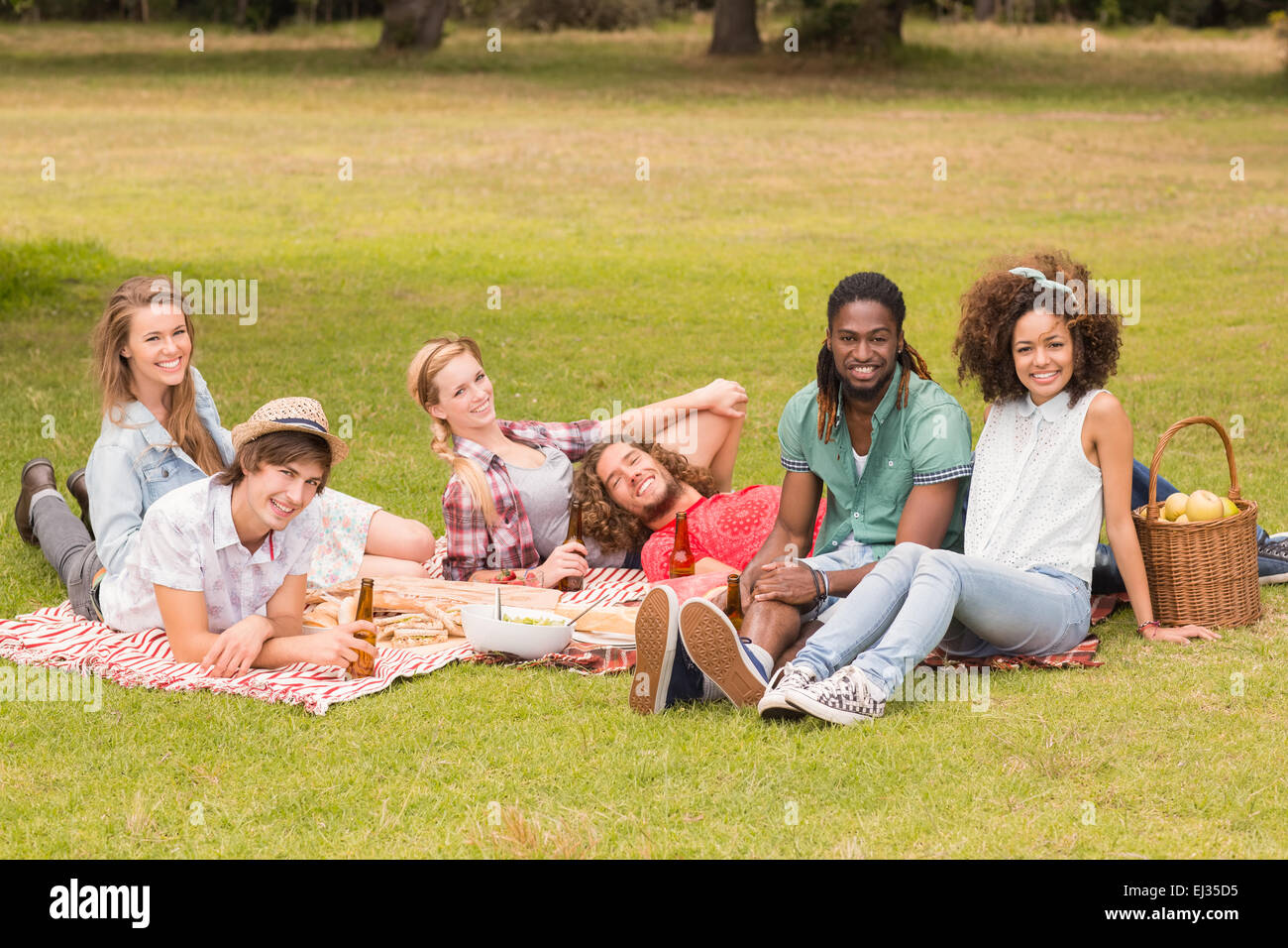 Happy friends in the park having picnic Stock Photo - Alamy