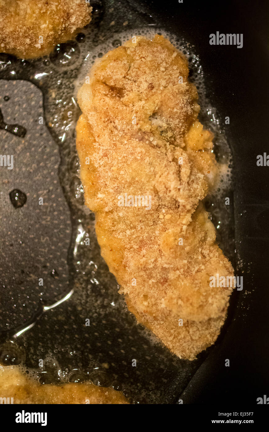 Closeup photo of chicken nugget frying in oil on pan Stock Photo Alamy