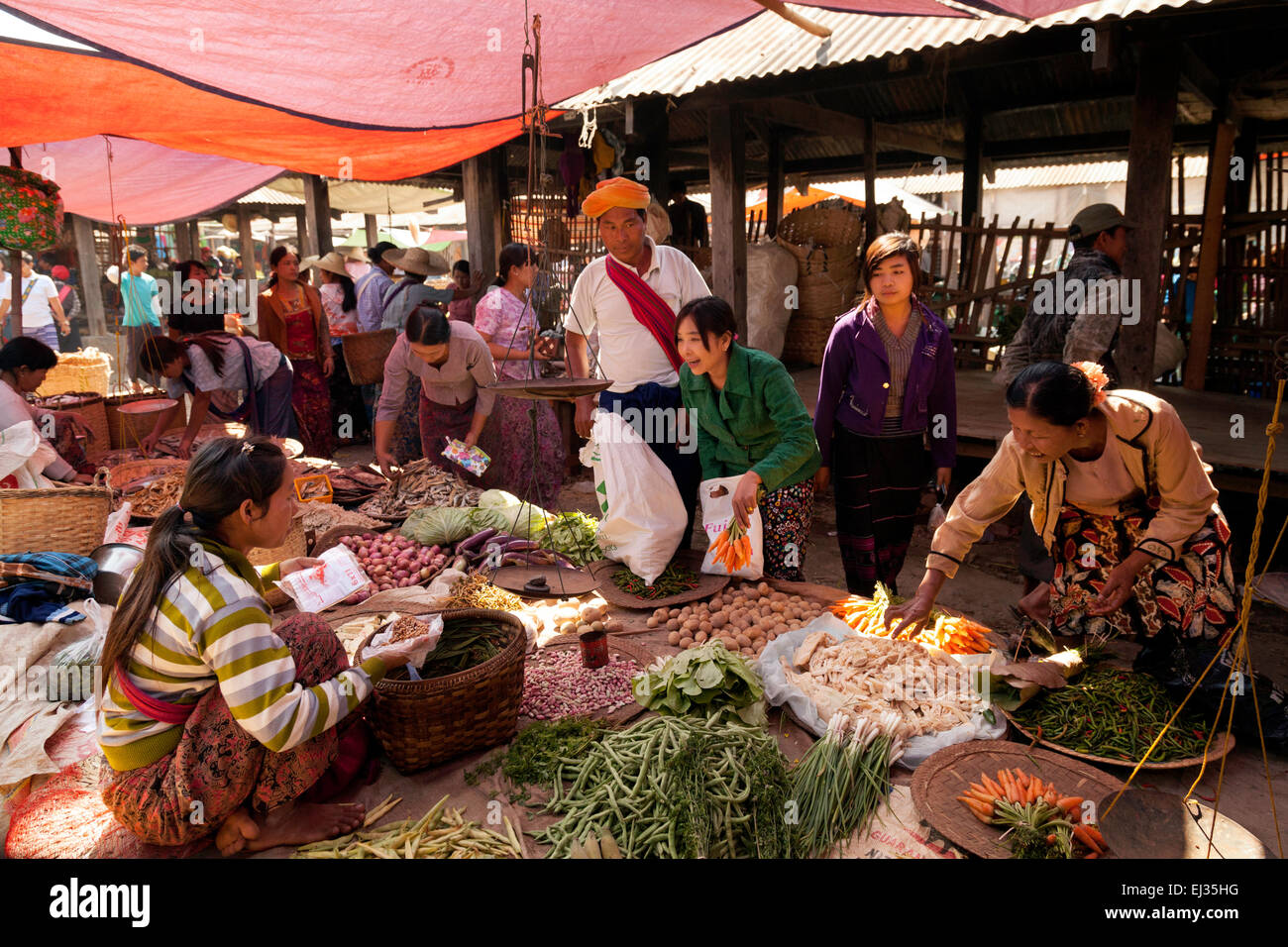 Local people buying food at a village market; Inle Lake ...