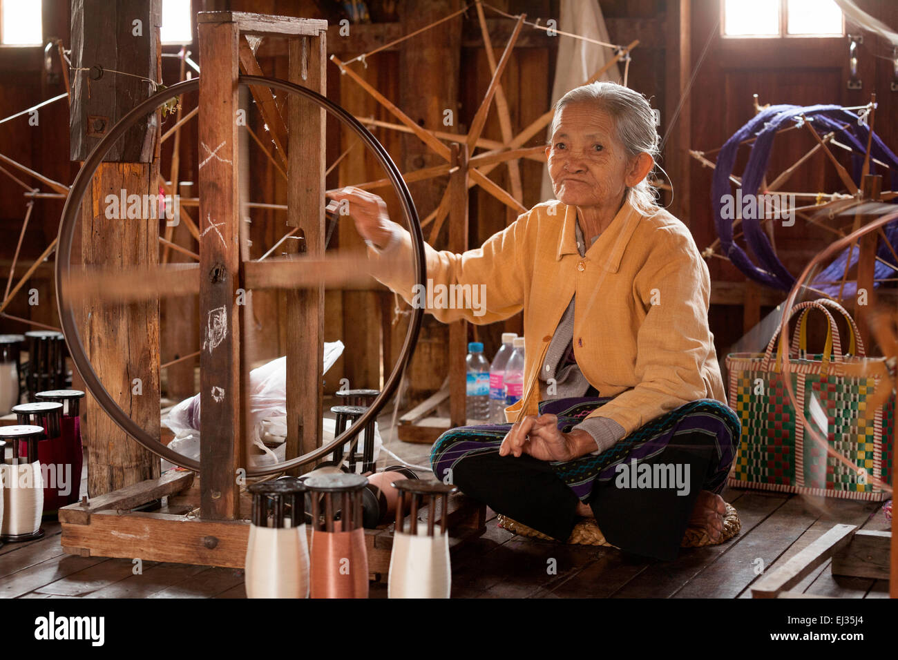 Woman making thread on a spinning wheel hi-res stock photography and images  - Alamy