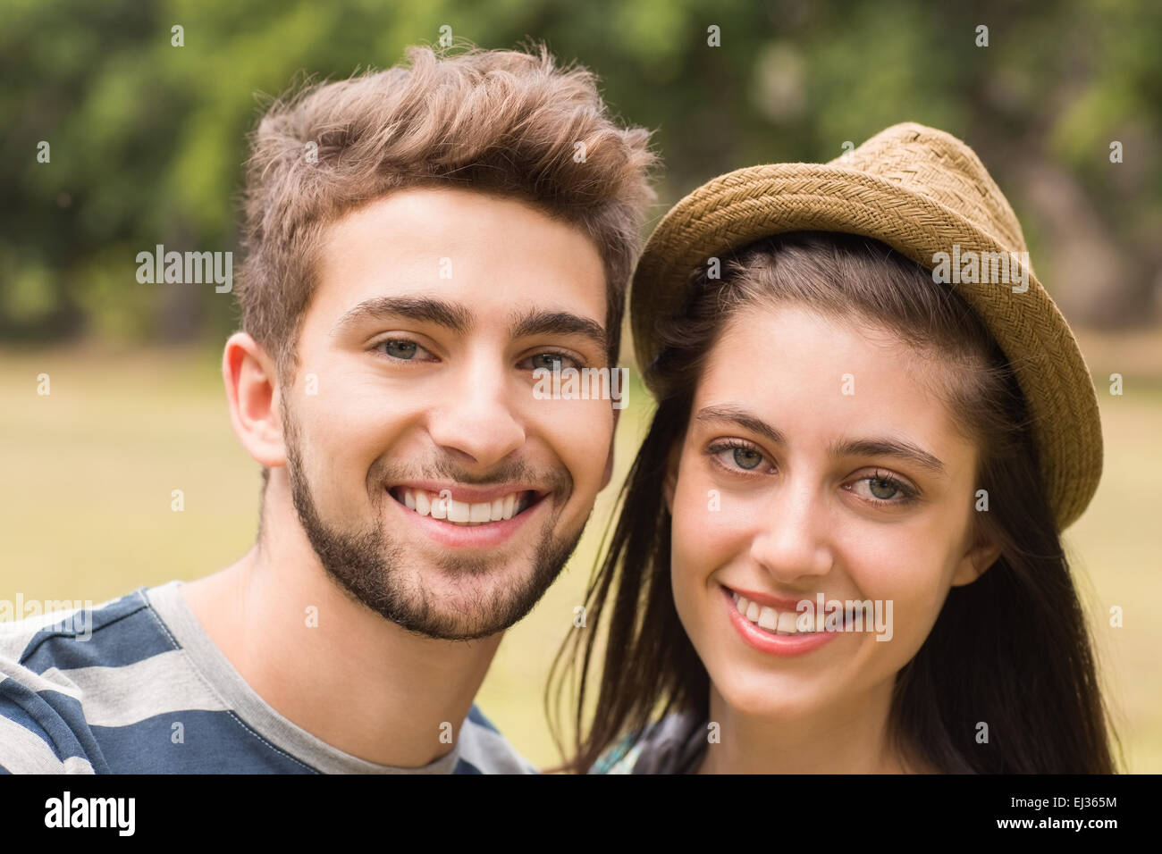 Young couple smiling at the camera Stock Photo - Alamy