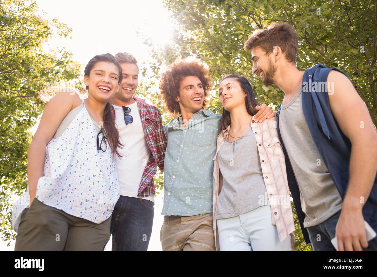 Happy friends in the park having beers Stock Photo - Alamy