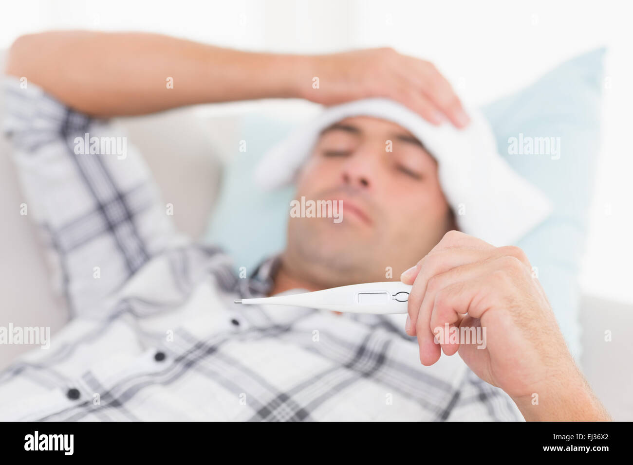 Man checking temperature on thermometer Stock Photo Alamy