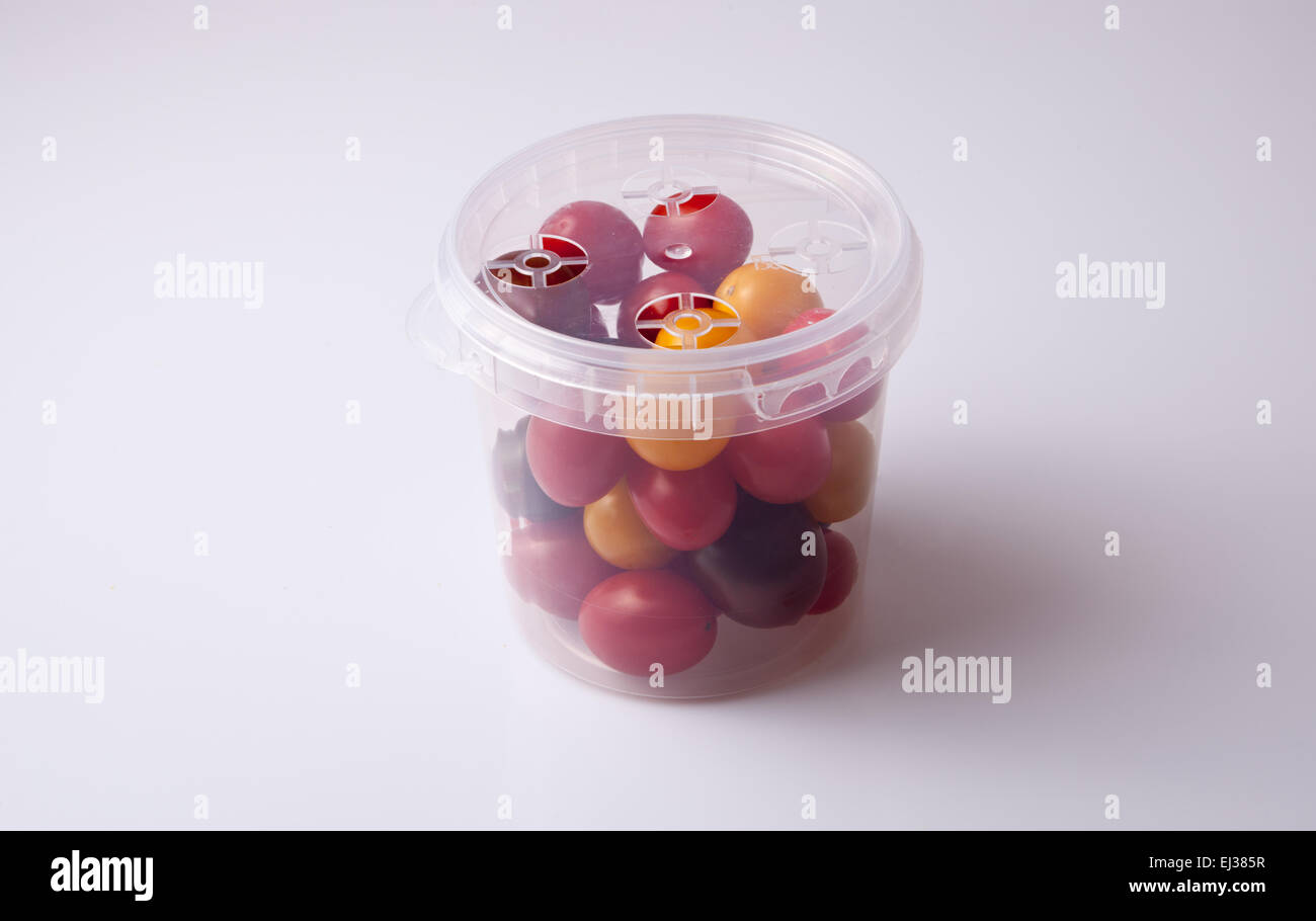 Bucket of colorful cherry tomatoes. Isolated over white background