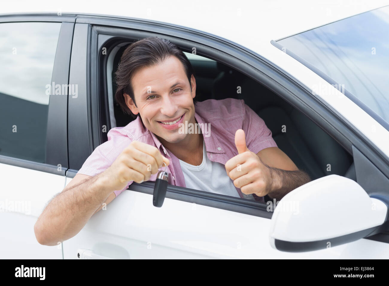 Man smiling and showing key Stock Photo - Alamy