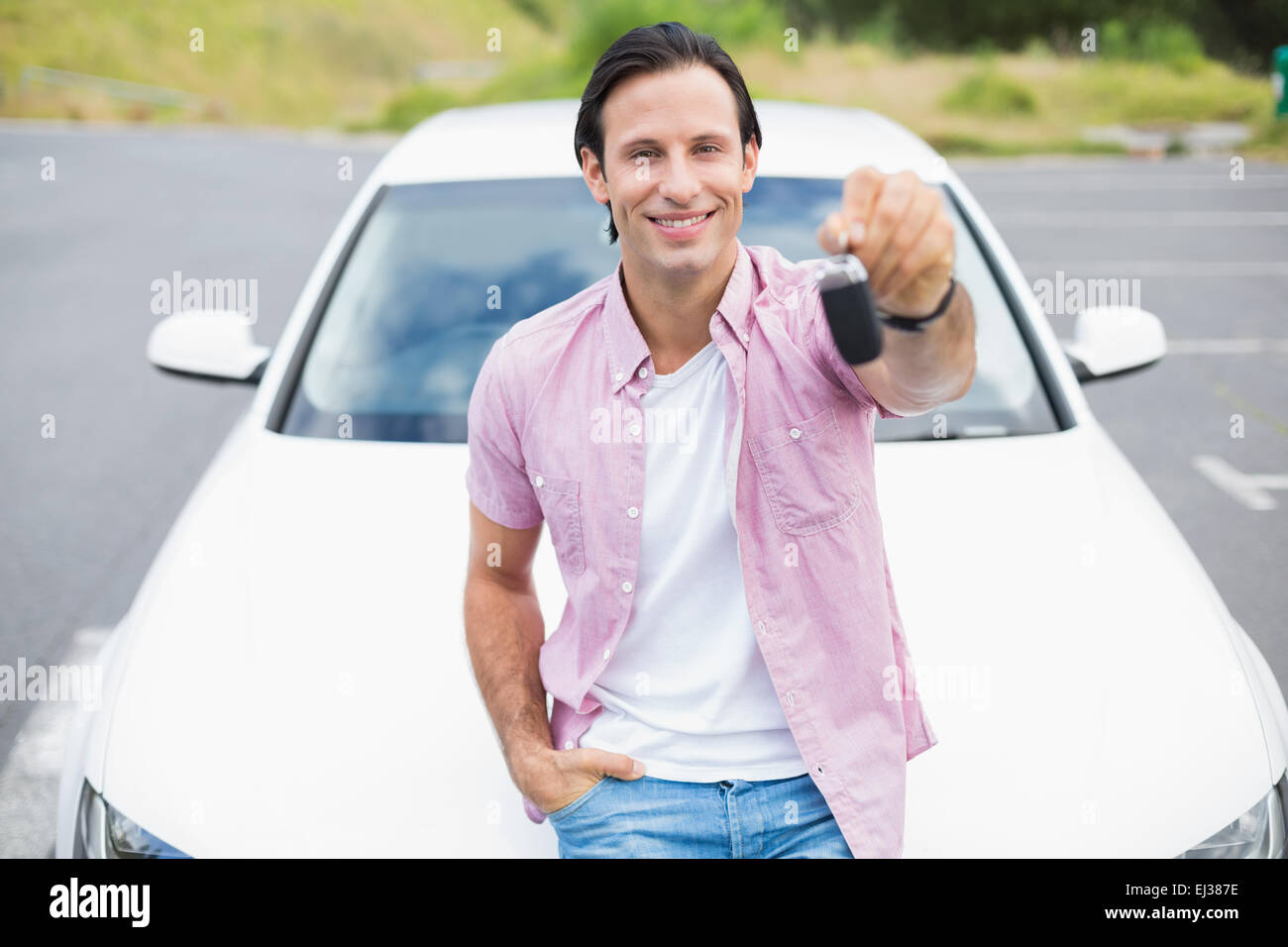 Man smiling and showing key Stock Photo - Alamy