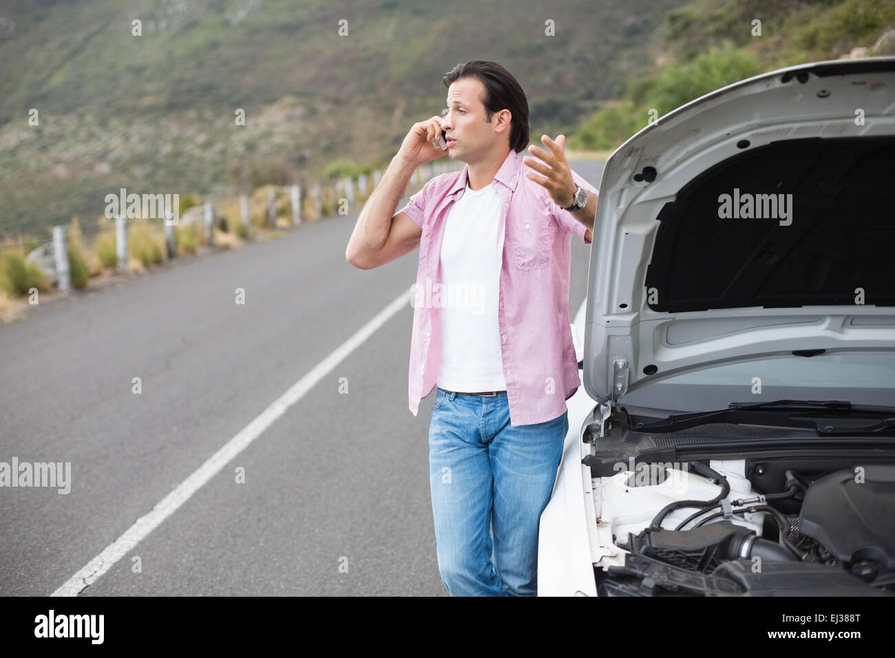Man after a car breakdown Stock Photo