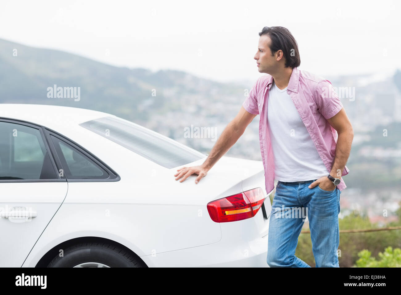 Man standing next to his car Stock Photo