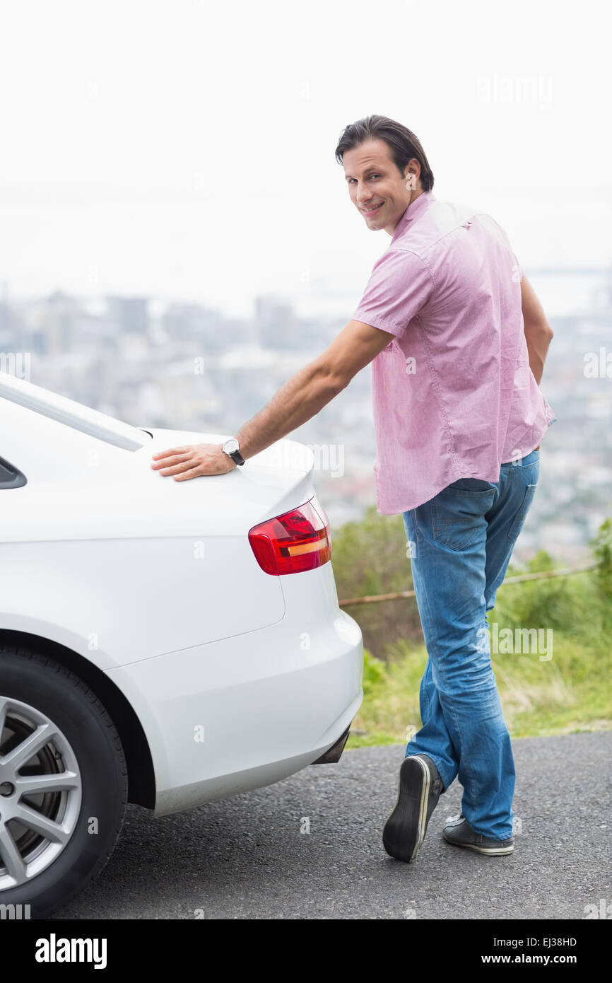 Smiling man standing next to his car Stock Photo