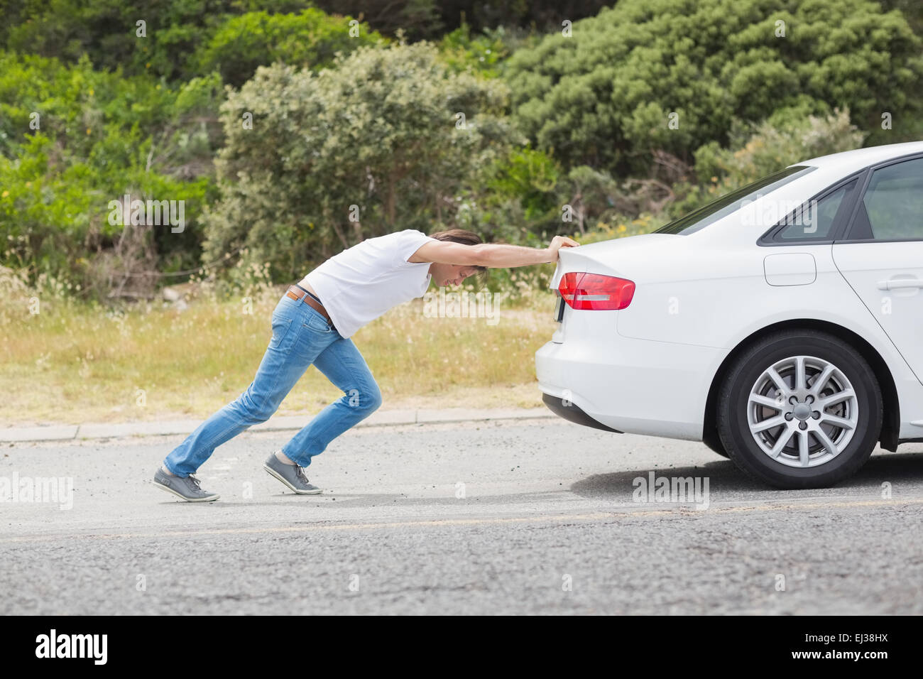 Man pushing his car Stock Photo