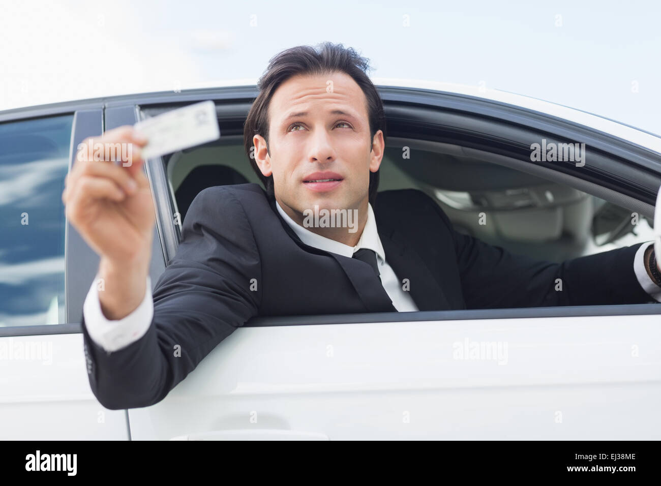 Businessman showing his driver license Stock Photo