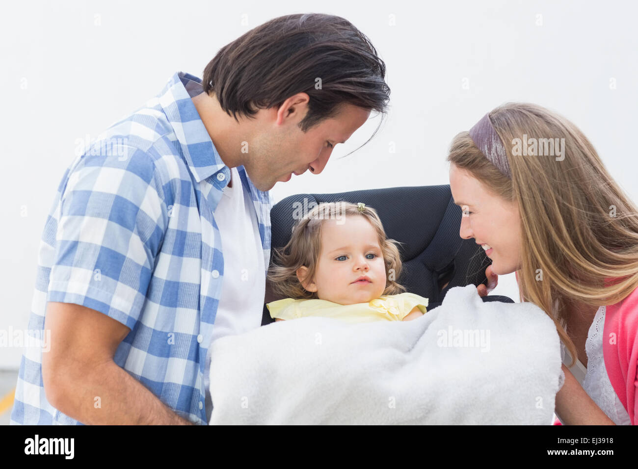 Parents carrying baby in his car seat Stock Photo