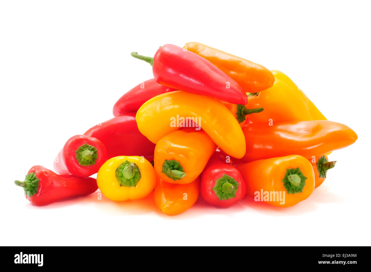 some sweet peppers of different colors, orange, red and yellow, on a