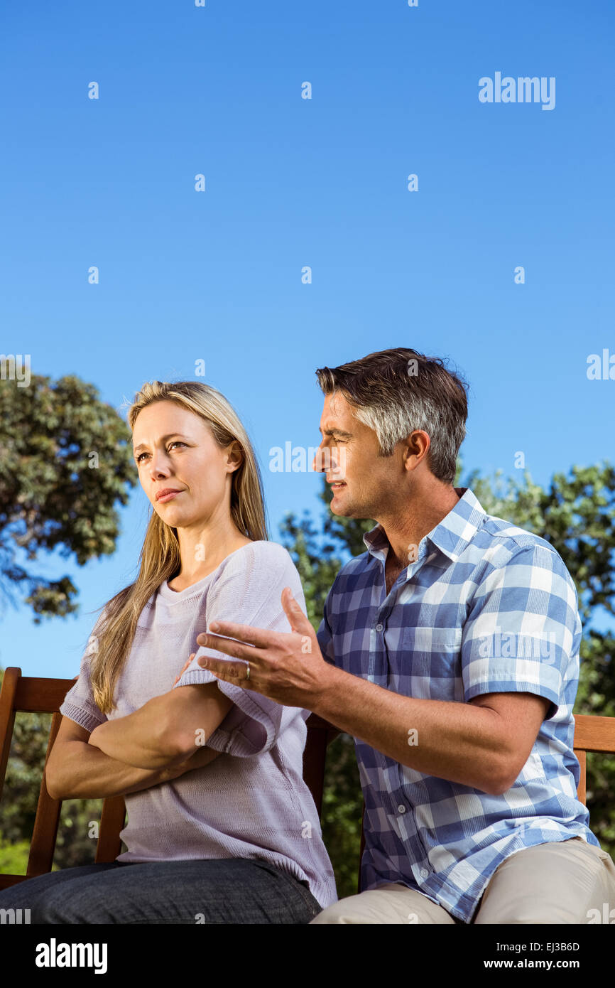 Couple having an argument on park bench Stock Photo - Alamy