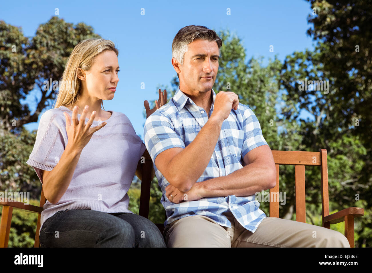 Couple having an argument on park bench Stock Photo - Alamy