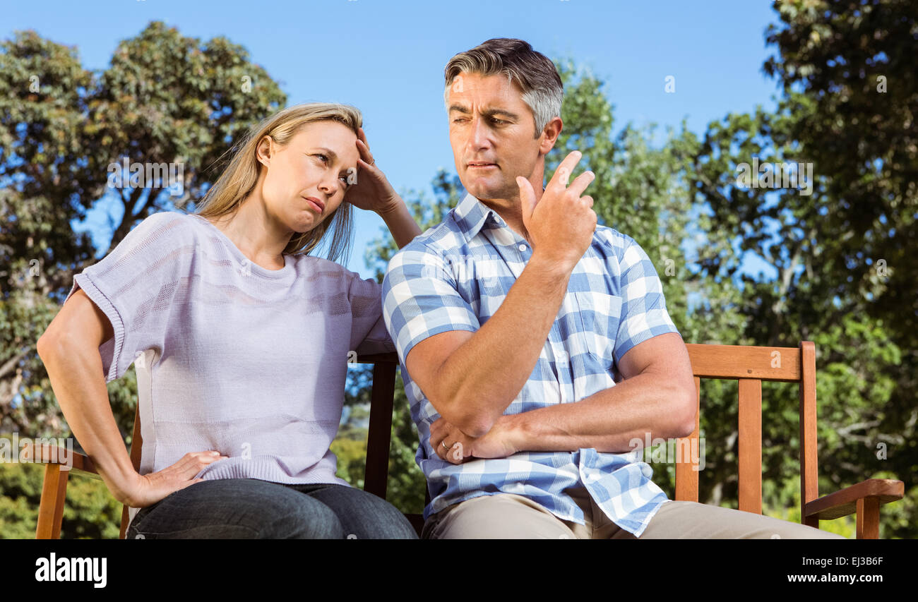 Couple having an argument on park bench Stock Photo - Alamy